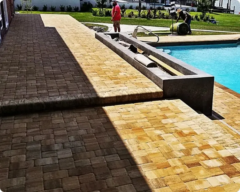 Paver pool deck with a raised spa wall