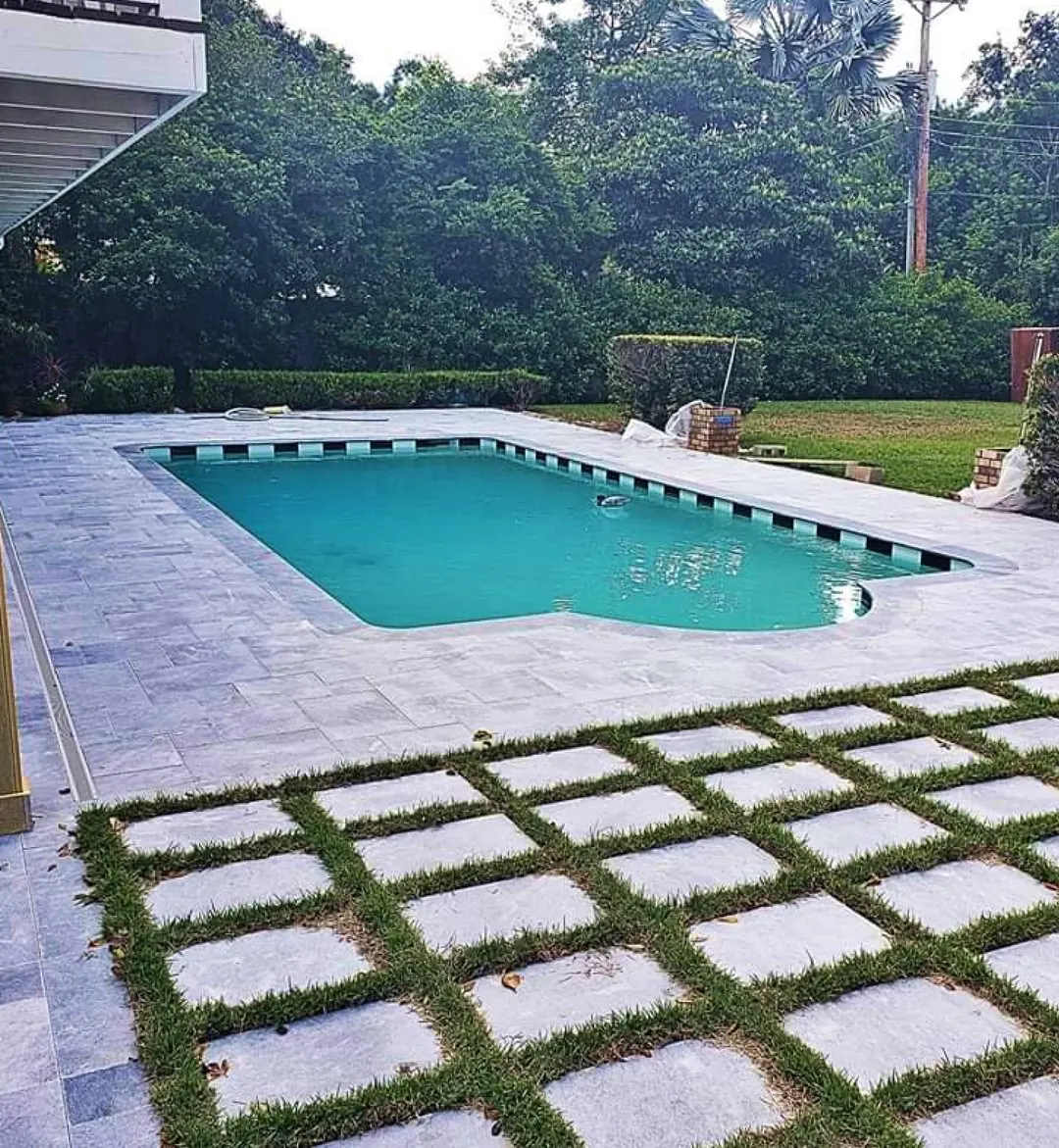 Pool deck of large pavers with turf joints